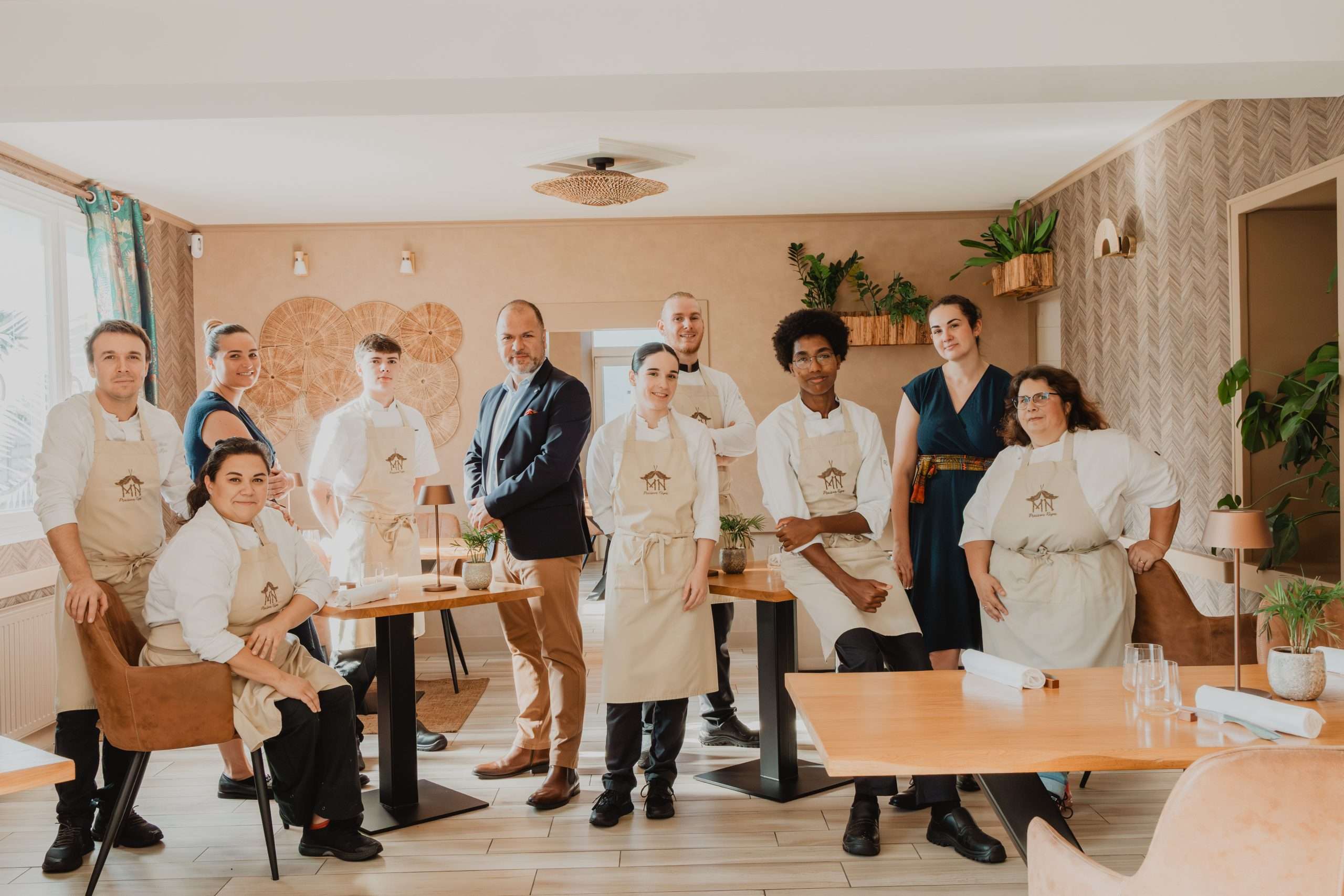 Photo de l'équipe de personnel alignée en rangée, souriante pour la photo de groupe.